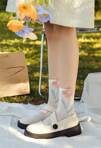 Detail of floral mesh crew socks paired with vintage beige platform Mary Jane shoes