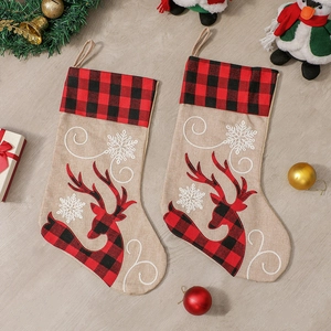 Christmas stocking set with reindeer embroidery and snowflake on rustic wooden background