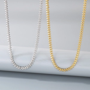 Detail of heart and arrow link chains in gold and silver stainless steel finishes