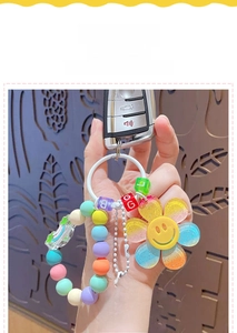 Detail of colorful beaded keychain with sunflower charm and Love heart pendant