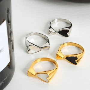 Set of four 18K gold plated heart rings with black and white enamel in a creative minimalist style