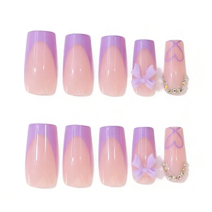 Detail of taro purple French press-on nails featuring 3D bows and rhinestone heart accents