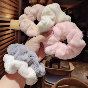 Soft plush scrunchies set in pink, white, grey and beige colors for elegant hair styling