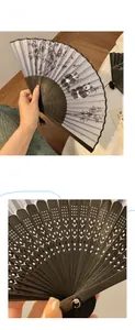 Detail of hand-held folding fan with panda ink painting and carved black bamboo frame