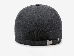 Detail view of the adjustable metal buckle and stitching on a dark gray winter baseball cap