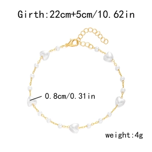 Detailed view of heart charms and faux pearls on a gold-tone anklet with dimensions