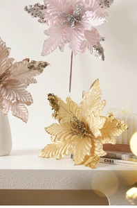 Close-up of sparkling sequined Christmas poinsettia flowers in champagne and pink tones