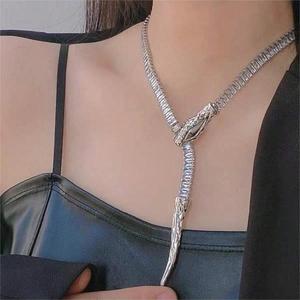 Elegant silver snake chain necklace with sparkling rhinestones worn on a fashion model