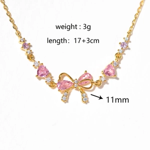 Detail of a gold-plated heart bracelet with pink stones and bow pendant size 11mm