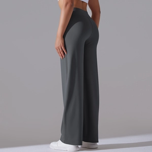 Detail view of dark grey high-waisted yoga pants with wide legs and fine stitching