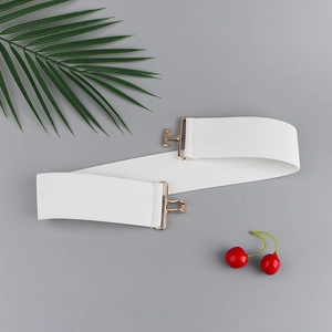 Close-up of white elastic waist belt with textured fabric and golden alloy buckle