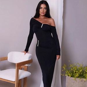 Detail of elegant black off-shoulder dress featuring vertical sparkling rhinestone strips