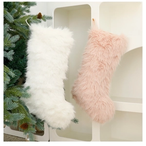 Close-up of soft faux fur Christmas stockings in white and pink for festive home decor