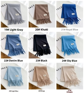 Detailed grid view of nine colorful solid tassel scarves in soft cashmere-like fabric