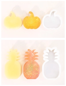 Detail showing pumpkin and pineapple silicone molds for DIY candles and resin crafts