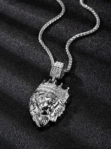 Close-up of silver lion head pendant with iced-out crown and sparkling crystals