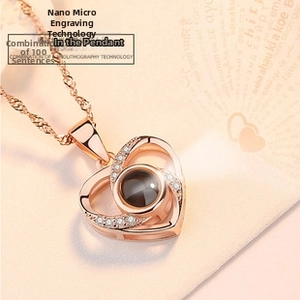 Detailed macro view of rose gold heart pendant with nano-projection technology and crystals