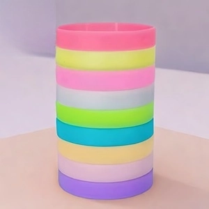 Stack of multi-colored silicone wristbands in soft macaron tones for sports fans