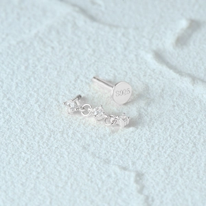 Macro view of S925 sterling silver flat back stud showing three diamonds and hallmark