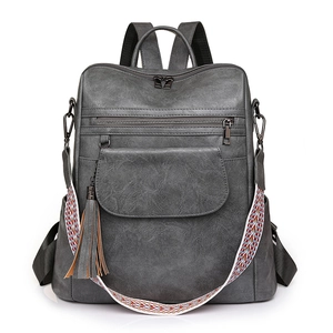 Sac à dos vintage gris pour femme en similicuir avec bandoulière colorée et pompon