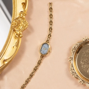 Elegant vintage GEDI gold oval watch with grey marble dial on silk background