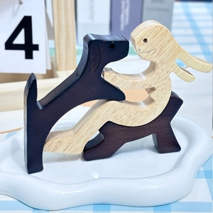 Handcrafted wooden dog memorial sculpture with abstract figures in dark and light wood finish
