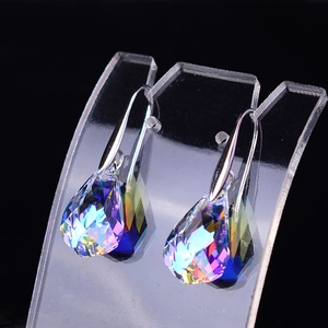 Macro shot of faceted teardrop crystal earrings with vibrant Aurora Borealis color coating