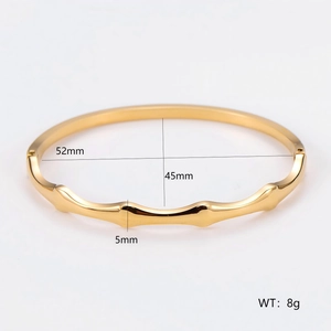 Gold minimalist wave texture stainless steel bangle with dimensions 52mm by 45mm