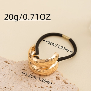 Detailed view of golden textured hair tie with size and weight measurement markers