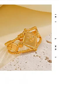 Detail of gold evil eye geometric ring on stone and silk background featuring retro design
