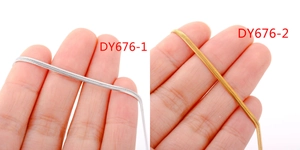 Detail of 18k gold and silver flat snake chains shown on fingers for size comparison