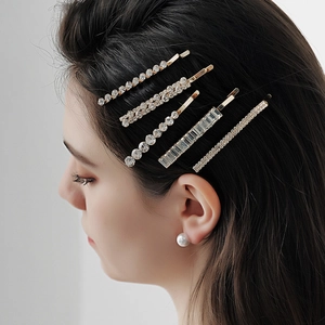 Elegant 5-piece gold hair clip set with sparkling rhinestones worn on hair by model