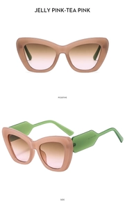 Detail view of cat eye sunglasses with jelly pink frame and green temples in macro