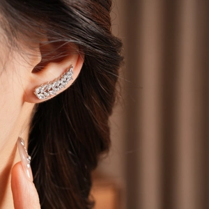 Detailed view of silver zircon leaf ear cuff worn elegantly on the upper cartilage