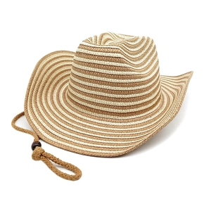Detail of two-tone woven straw beach hat featuring a rustic adjustable chin strap