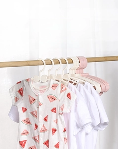 Detail of pink bow-shaped non-slip baby hanger with a watermelon print infant romper