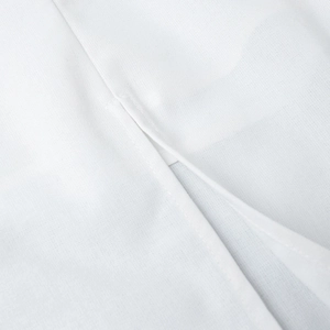 Detail of white cotton-linen fabric showing square neck stitching and weave texture