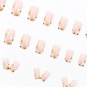 French nude pink press-on nails with white and yellow daisy flower pattern glossy finish