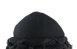 Detail of a black Kufi hat with woven tassel trim and satin lining for hair protection