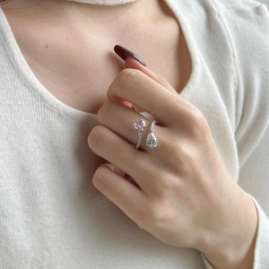 Detailed shot of S925 silver ring featuring pink heart and pear-shaped zircon stones