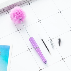 DIY plastic beaded ballpoint pen featuring a fluffy purple plush ball and glitter barrel