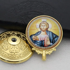 Detail of golden metal base with ornate relief and Christ Pantocrator religious icon