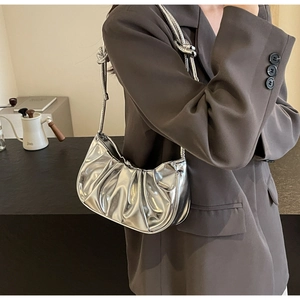 Detail of silver metallic pleated hobo bag with unique knotted handle design for women