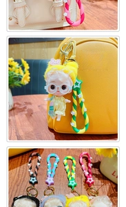 Movable cartoon doll keychain showing flexible joints and removable colorful clothes