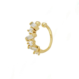 Macro view of gold ear cuff with rectangular zircons in a geometric open design