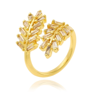 Macro shot of gold leaf ring with micro-paved rectangular zircons on a white background