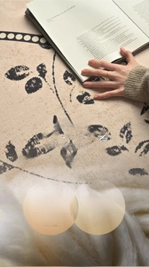 Detailed texture of cotton polyester blend round rug with floral branch patterns