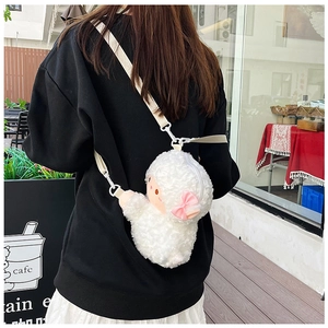 Close-up of a soft white plush sheep crossbody bag with a cute pink bow and beige strap