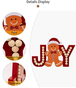 Detail view of wooden JOY sign with gingerbread man and red beaded decorative elements