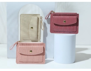 Detail of crocodile pattern PU leather card holders in beige, pink and purple colors